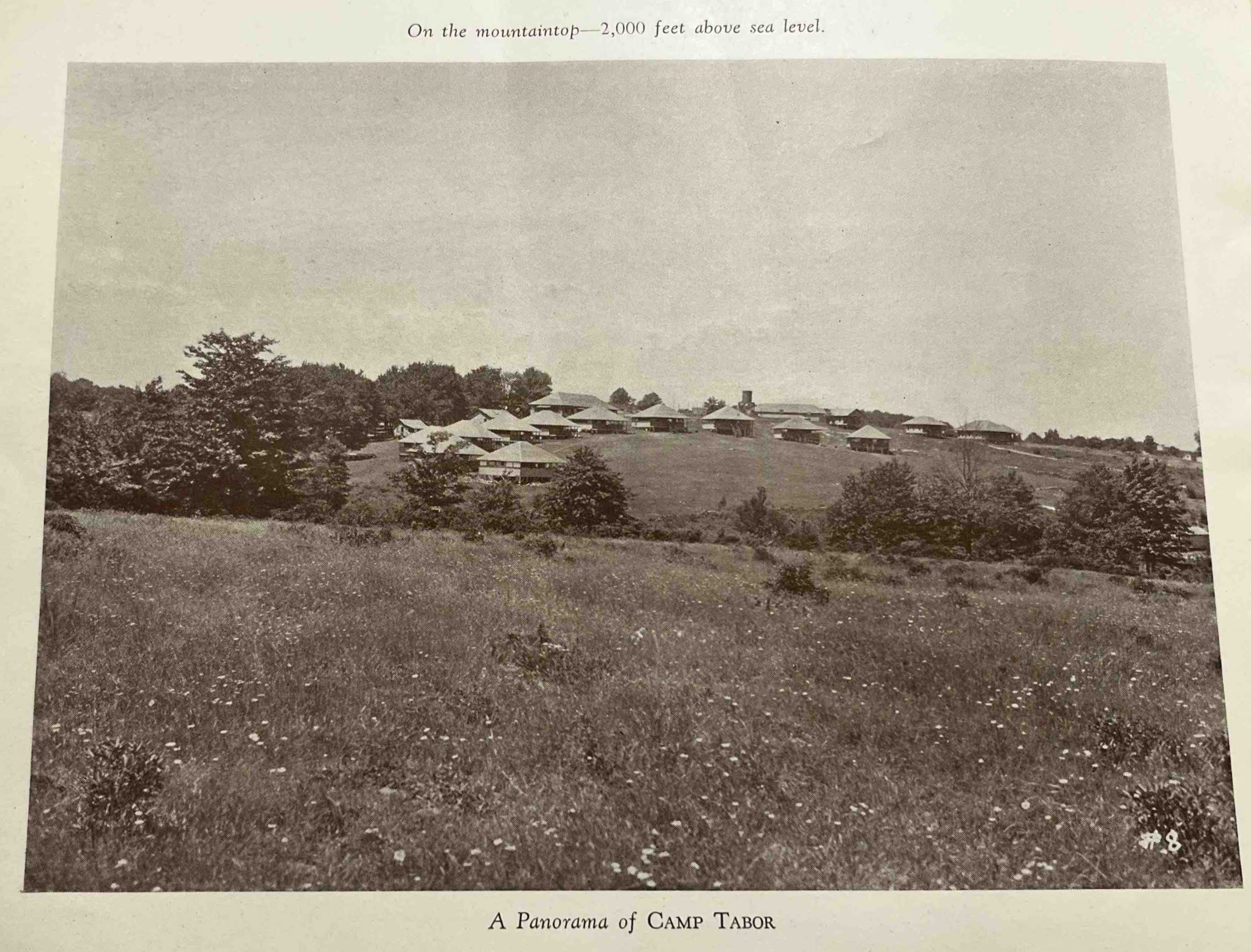 A photograph from the 1931 Camp Tabor yearbook facing Camp Tabor likely taken from Frog Island next to Fork Mountain Pond