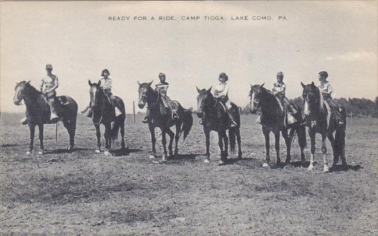 A postcard with a photograph of a group of boys on horses and the title "Ready For A Ride, Camp Tioga, Lake Como, PA"