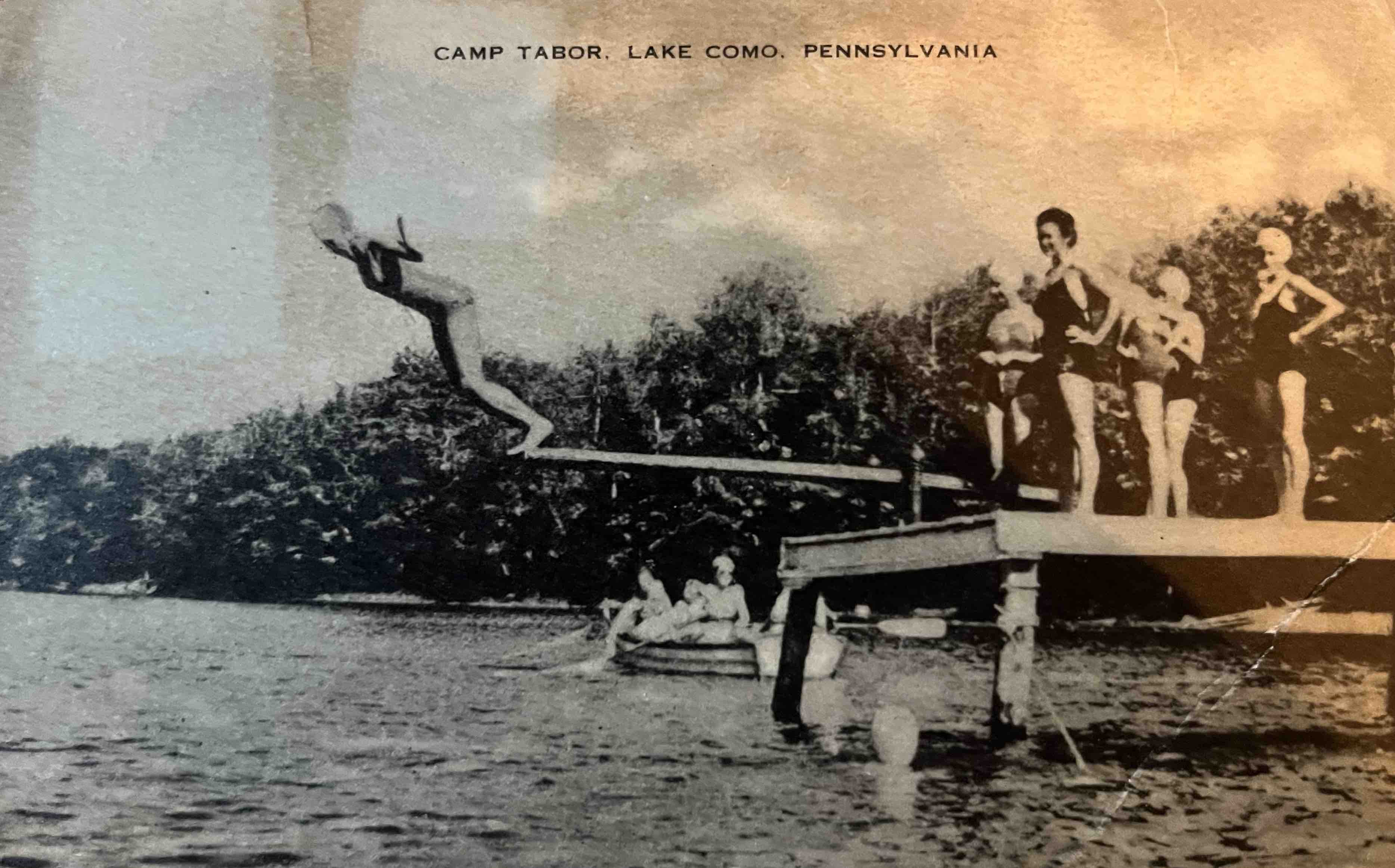 A postcard with a photograph of a group jumping into a lake and the title "Camp Tabor, Lake Como, Pennsylvania"